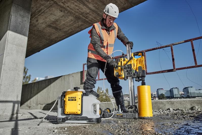 DEWALT DCE6820N, DCE6820N-XJ drilling tool in use at a construction site outdoors. Photography category.