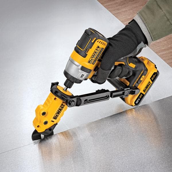 DEWALT power tool with attachment cutting sheet metal, operated by a gloved hand.